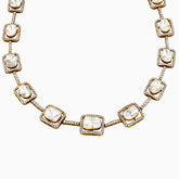 Gold necklace with diamond-studded square pendants and white stone centers